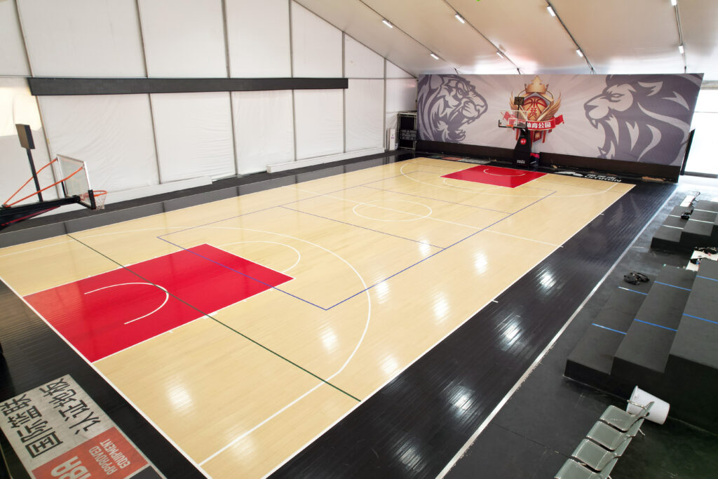 Indoor basketball court sports flooring project with completed court surface and line markings