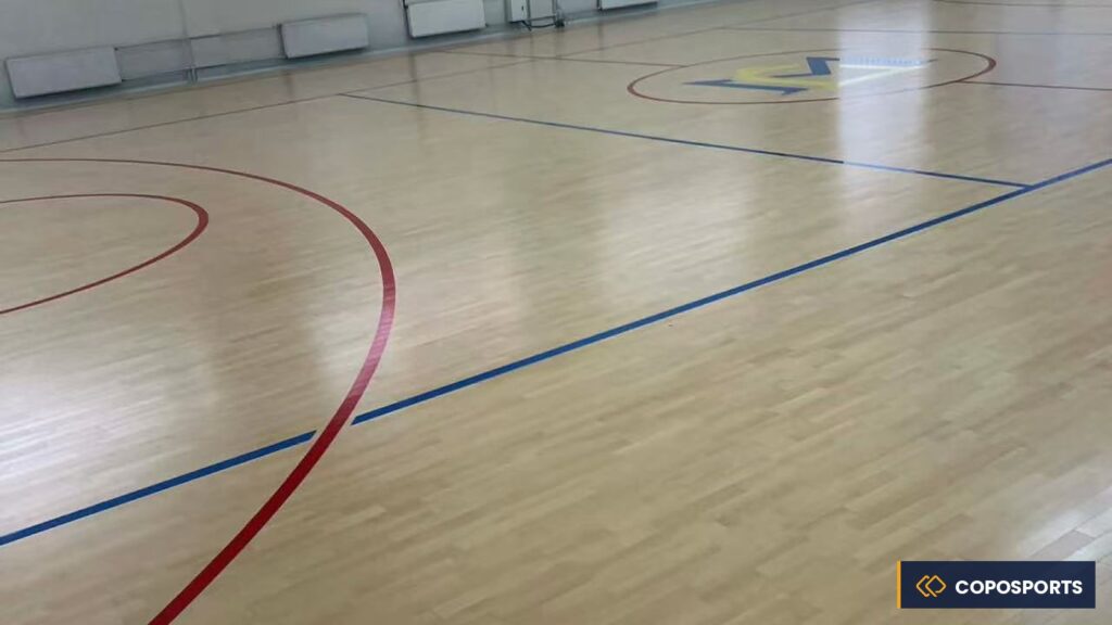 Completed school gym sports flooring project with multi-line court markings